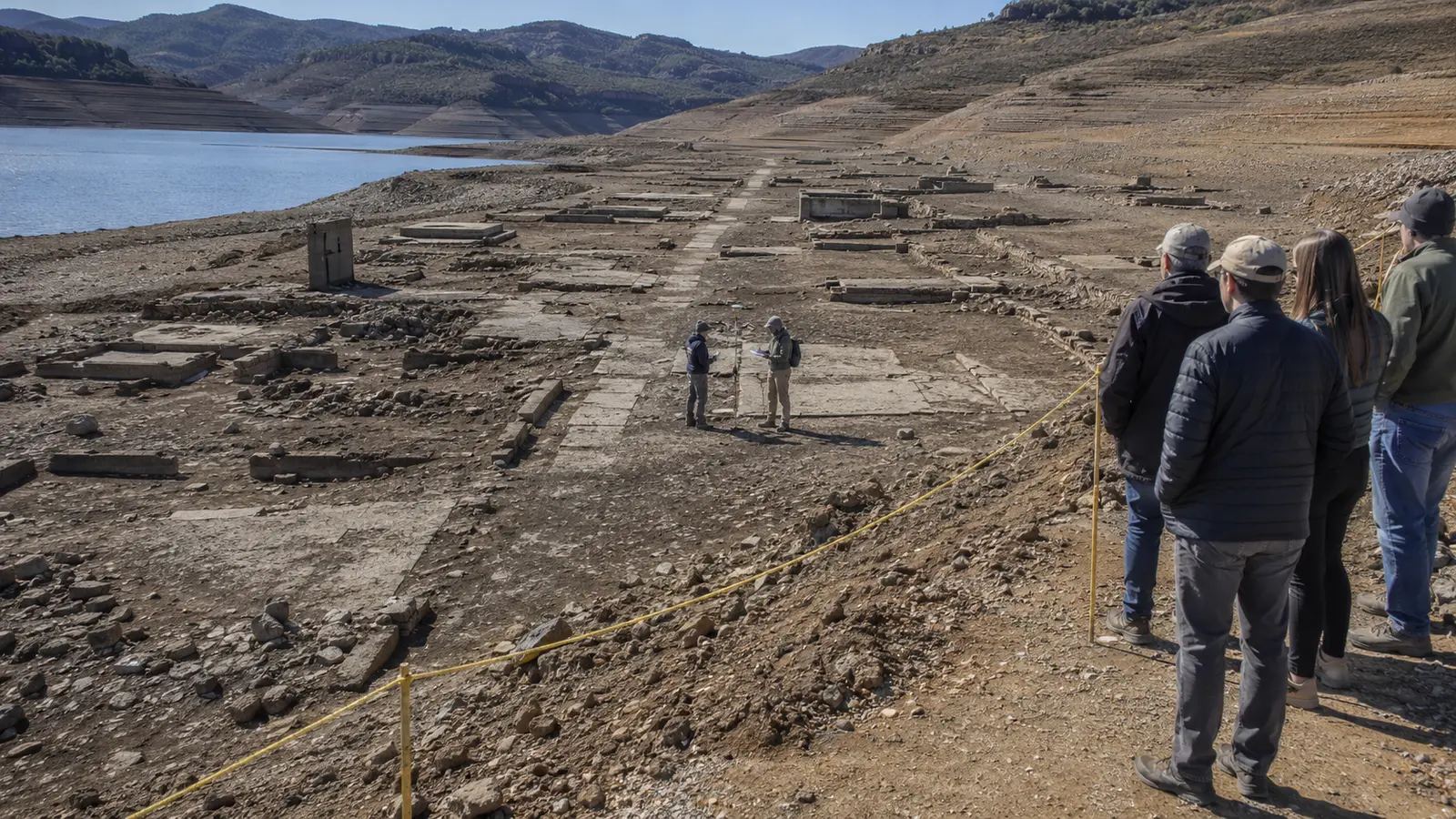 Low reservoir water exposing town foundations studied from a managed route